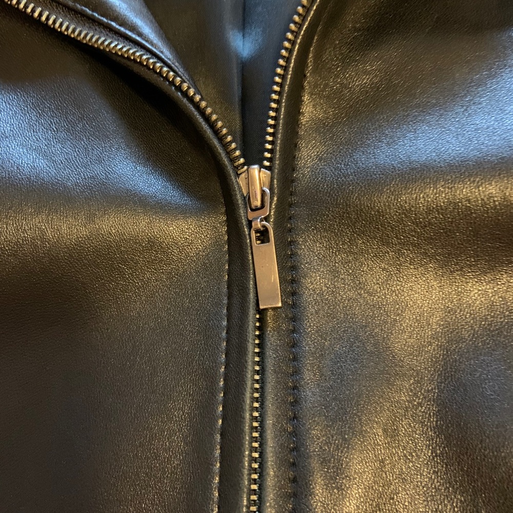 Women’s plus size black leather mid thigh jacket.